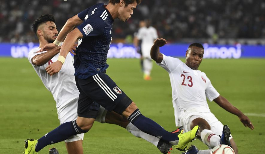 Qatar's defender Tarek Salman, left, and Qatar's defender Assim Madibo, right, challenge Japan's defender Hiroki Sakai, center, during the AFC Asian Cup final match between Japan and Qatar in Zayed Sport City in Abu Dhabi, United Arab Emirates, Friday, Feb. 1, 2019. (AP Photo/Hassan Ammar)