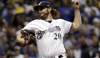 FILE - In this Oct. 19, 2018, file photo, Milwaukee Brewers starting pitcher Wade Miley throws during the first inning of Game 6 of the National League Championship Series baseball game against the Los Angeles Dodgers in Milwaukee. The Houston Astros filled an opening in their rotation, agreeing to a $4.5 million, one-year contract with 32-year-old left-hander Miley. (AP Photo/Matt Slocum, File)