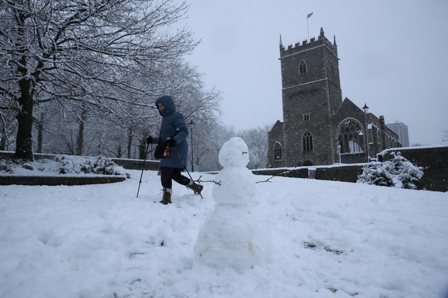 Snow falls over St Peter's Church in Bristol, south west England, Friday, Feb. 1, 2019. (AP Photo/Matt Dunham)