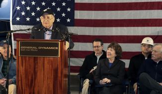 Former Sen. Carl Levin, of Michigan, addresses a gathering at Bath Iron Works, where a warship that bears his name is under construction, Friday, Feb. 1, 2019, in Bath, Maine. In the front row from left are U.S. Navy Secretary Richard Spencer, Levin, U.S. Sen. Susan Collins (R-Me.) and U.S. Sen. Angus King (I-Me.). (AP Photo/David Sharp)