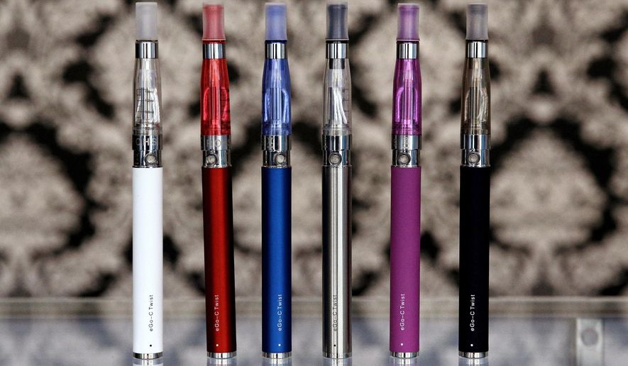 FILE - In this April 23, 2014 file photo, E-cigarettes appear on display at Vape store in Chicago. The Vermont House is expected to give final approval on Friday, Feb. 1, 2019 to a proposal to tax on e-cigarettes. (AP Photo/Nam Y. Huh, File)