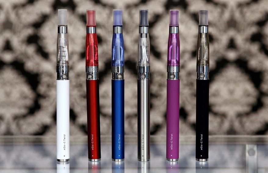FILE - In this April 23, 2014 file photo, E-cigarettes appear on display at Vape store in Chicago. The Vermont House is expected to give final approval on Friday, Feb. 1, 2019 to a proposal to tax on e-cigarettes. (AP Photo/Nam Y. Huh, File)