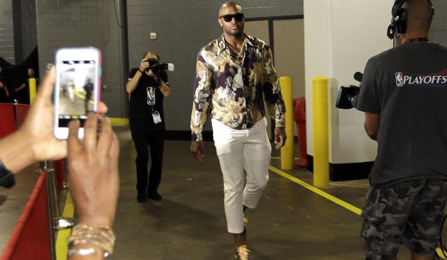 FILE - In this May 17, 2018, file photo,Houston Rockets&#x27; P.J. Tucker arrives for Game 2 of the team&#x27;s NBA basketball Western Conference finals against the Golden State Warriors in Houston. Tucker has become such a fashion icon that he&#x27;s no longer simply wearing designer pieces, he&#x27;s making them.(AP Photo/David J. Phillip, File)