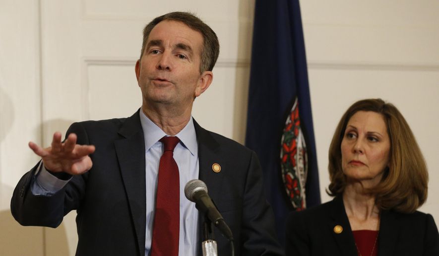 Virginia Gov. Ralph Northam, left, gestures as his wife, Pam, listens during a news conference in the Governors Mansion at the Capitol in Richmond, Va., Saturday, Feb. 2, 2019. Northam is under fire for a racial photo that appeared in his college yearbook. (AP Photo/Steve Helber)