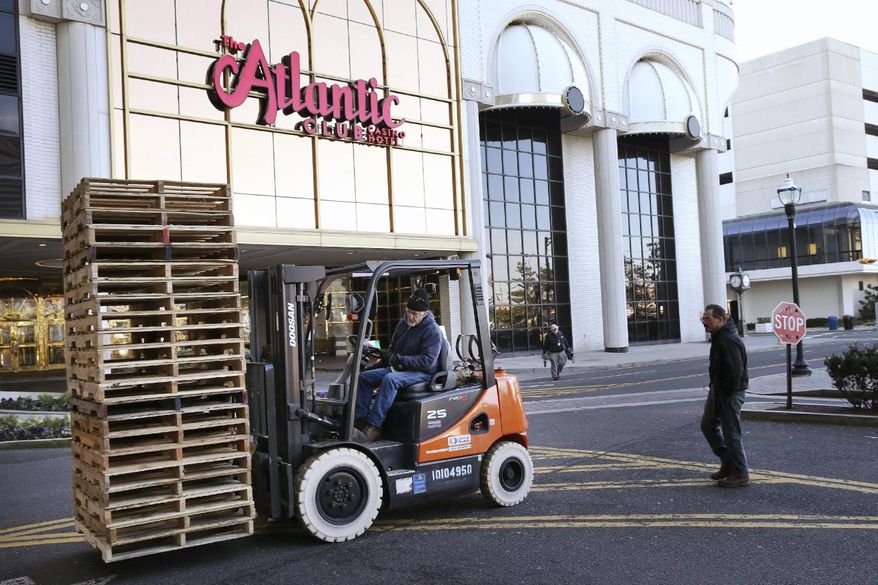 FILE- In this Jan. 13, 2014 file photo, a forklift operator moves pallets at the former Atlantic Club Casino Hotel in Atlantic City, NJ. According to a Saturday, Feb. 2, 2019, report in The Press of Atlantic City, the owner of the former Atlantic Club Casino Hotel denies the shuttered property has been sold despite the filing of a notice of settlement last month. (Michael Ein/The Press of Atlantic City via AP, File)