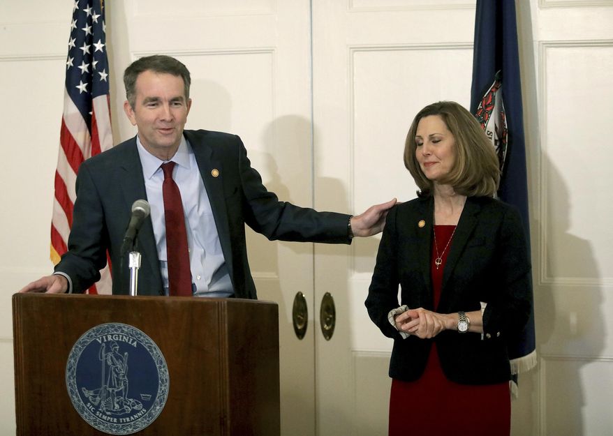 Virginia Gov. Ralph Northam, left, with his wife Pam at his side, speaks during a press conference in the Executive Mansion on Saturday, Feb. 2, 2019. Northam is under fire for a racial photo that appeared in his college yearbook. (Steve Earley/The Virginian-Pilot via AP)
