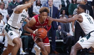 Indiana&#39;s Romeo Langford, center, drives between Michigan State&#39;s Kenny Goins, left, and Aaron Henry (11) during the first half of an NCAA college basketball game, Saturday, Feb. 2, 2019, in East Lansing, Mich. (AP Photo/Al Goldis)