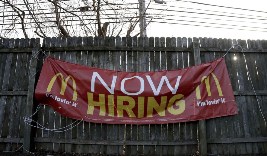 FILE- In this Jan. 3, 2019, file photo an employment sign hangs from a wooden fence on the property of a McDonald&#39;s restaurant in Atlantic Highlands, N.J. On Friday, Feb. 1, the U.S. government issues the January jobs report, which will reveal the latest unemployment rate and number of jobs U.S. employers added. (AP Photo/Julio Cortez, File)