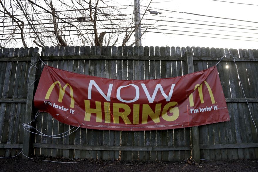 FILE- In this Jan. 3, 2019, file photo an employment sign hangs from a wooden fence on the property of a McDonald&#39;s restaurant in Atlantic Highlands, N.J. On Friday, Feb. 1, the U.S. government issues the January jobs report, which will reveal the latest unemployment rate and number of jobs U.S. employers added. (AP Photo/Julio Cortez, File)