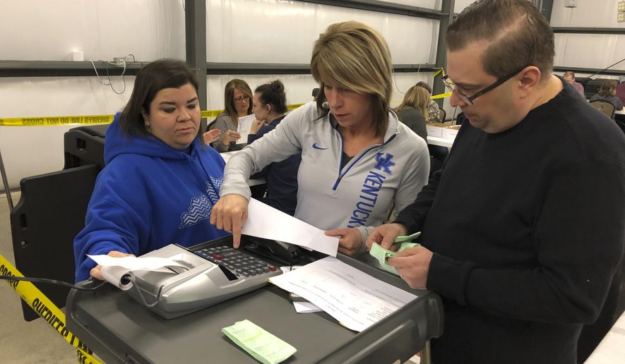 From right, Daviess County Chief Deputy Clerk Richard House and deputy clerks Tonya Payne and Kelli Shively review vote totals during a recount of Kentucky House district 13 on Saturday, Feb. 2, 2019, in Owensboro, Ky. Democrat Jim Glenn won the race by one vote in November. But the Republican-controlled legislature ordered a recount at the request of GOP candidate DJ Johnson.  (AP Photo/Adam Beam)