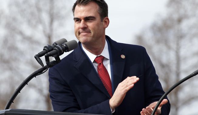 FILE - In this Jan. 14, 2019, file photo, Oklahoma Gov. Kevin Stitt applauds as he gives his inaugural speech during ceremonies in Oklahoma City. Stitt and GOP leaders in the House and Senate each expressed willingness on Wednesday to consider some version of a Medicaid expansion that would extend health insurance to tens of thousands of Oklahoma’s uninsured. (AP Photo/Sue Ogrocki, File)