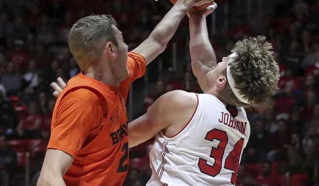 Utah center Jayce Johnson (34) is fouled by Oregon State forward Kylor Kelley (24) while shooting during the second half of an NCAA college basketball gamep Saturday, Feb. 2, 2019, in Salt Lake City. Oregon State won 81-72. (AP Photo/Chris Nicoll)
