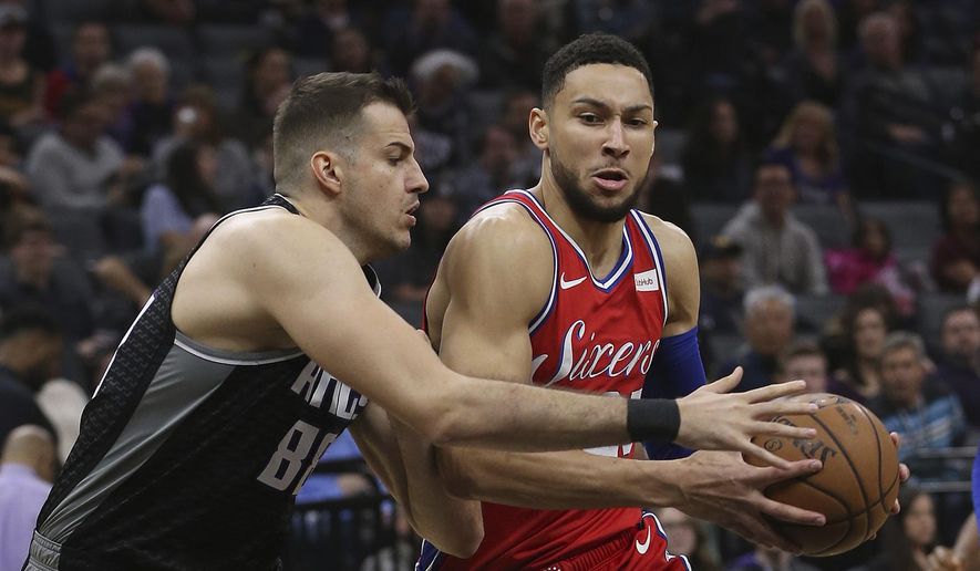 Philadelphia 76ers guard Ben Simmons, right, drives to the basket against Sacramento Kings forward Nemanja Bjelica, left, during the first quarter of an NBA basketball game Saturday, Feb. 2, 2019, in Sacramento, Calif. (AP Photo/Rich Pedroncelli)
