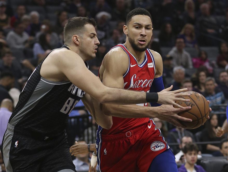 Philadelphia 76ers guard Ben Simmons, right, drives to the basket against Sacramento Kings forward Nemanja Bjelica, left, during the first quarter of an NBA basketball game Saturday, Feb. 2, 2019, in Sacramento, Calif. (AP Photo/Rich Pedroncelli)