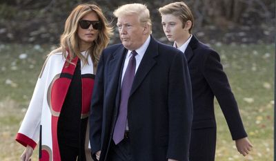 President Donald Trump accompanied by first lady Melania Trump, and their son Barron, right, walks towards Marine One on the South Lawn of the White House in Washington, Tuesday, Nov. 20, 2018, for a short trip to Andrews Air Force Base, Md., and then on to Palm Beach Fla., and Mar-a-Lago for Thanksgiving (AP Photo/Andrew Harnik)
