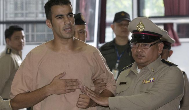 Detained Bahraini soccer player Hakeem al-Araibi, front left, arrives at the criminal court in Bangkok, Thailand Monday, Feb. 4, 2019. Al-Araibi has said he fled his home country due to political repression and human rights groups and activists fear he risks torture if he is sent back. Bahrain wants him returned to serve a 10-year prison sentence he received in absentia in 2014 for vandalizing a police station, which he denies. (AP Photo/Sakchai Lalit)
