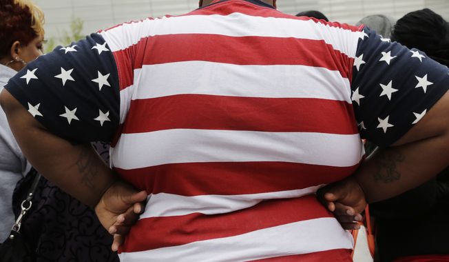 This May 8, 2014, file photo shows an overweight man in New York. (AP Photo/Mark Lennihan, File)