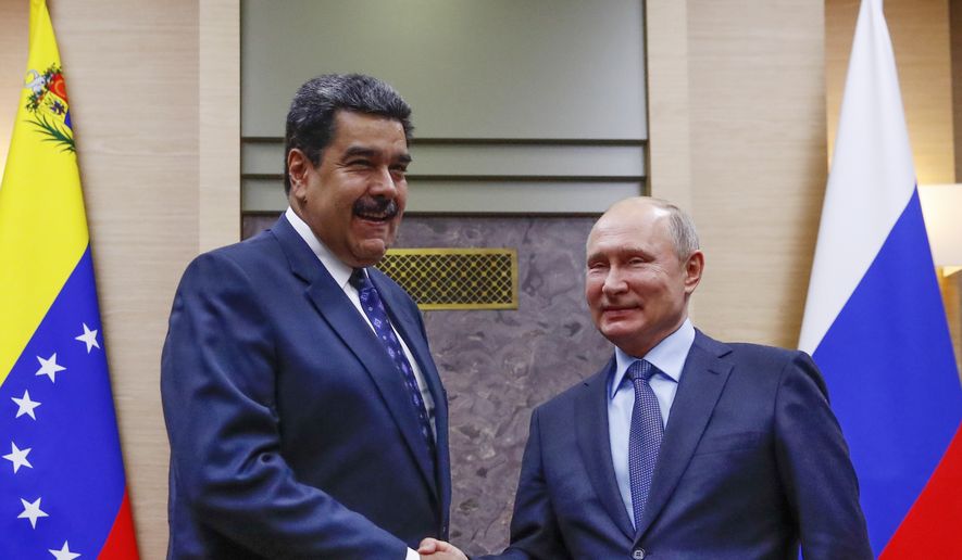 Russian President Vladimir Putin, right, shakes hands with his Venezuelan counterpart Nicolas Maduro during their meeting at the Novo-Ogaryovo residence outside in Moscow, Russia, Wednesday, Dec. 5, 2018. (Maxim Shemetov/Pool Photo via AP)