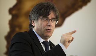In this photo taken on Sunday, Feb. 3, 2019, former regional Catalan President Carles Puigdemont speaks during an interview with The Associated Press at Puigdemont&#39;s resident in Waterloo, near Brussels, after he fled from Spain to avoid arrest following Catalonia’s failed secession bid in 2017.  Puigdemont says that Spain will be seeking “vengeance” instead of justice when 12 of his separatist allies stand trial next week. (AP Photo/Francisco Seco)