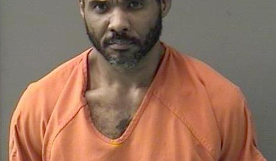 This undated booking photo released by Bell County Sheriff's Office shows Cedric Marks. Authorities say surveillance video helped police locate the MMA fighter facing murder charges after he escaped a prison van in Texas. The police chief in Conroe, Texas says Marks was found Sunday hiding inside a 55-gallon trash can. Marks is suspected in the deaths of his ex-girlfriend and her friend. Their bodies were found buried in a shallow grave in Clearview, Oklahoma, on Jan. 15. (Bell County Sheriff's Office via AP)
