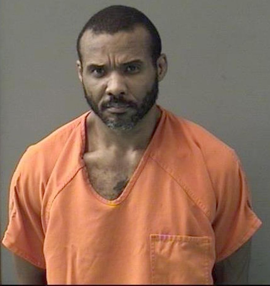 This undated booking photo released by Bell County Sheriff's Office shows Cedric Marks. Authorities say surveillance video helped police locate the MMA fighter facing murder charges after he escaped a prison van in Texas. The police chief in Conroe, Texas says Marks was found Sunday hiding inside a 55-gallon trash can. Marks is suspected in the deaths of his ex-girlfriend and her friend. Their bodies were found buried in a shallow grave in Clearview, Oklahoma, on Jan. 15. (Bell County Sheriff's Office via AP)