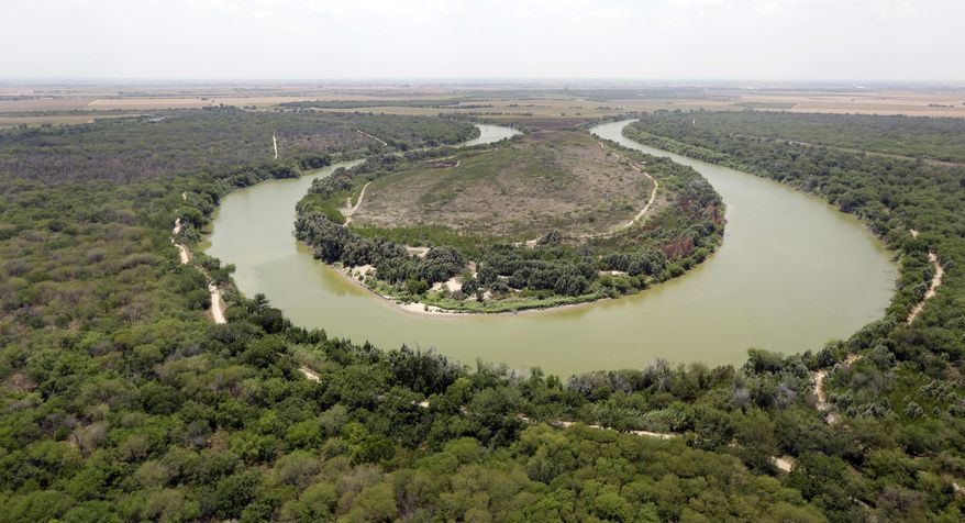 FILE - In this July 24, 2014, file photo, a bend in the Rio Grand is viewed from a Texas Department of Public Safety helicopter on patrol over in Mission, Texas. The U.S. government is preparing to begin construction of more border walls and fencing in South Texas&#39; Rio Grande Valley, likely on federally-owned land set aside as wildlife refuge property. Heavy construction equipment is supposed to arrive starting Monday. A photo posted by the nonprofit National Butterfly Center shows an excavator parked on its property. (AP Photo/Eric Gay, Pool, File)
