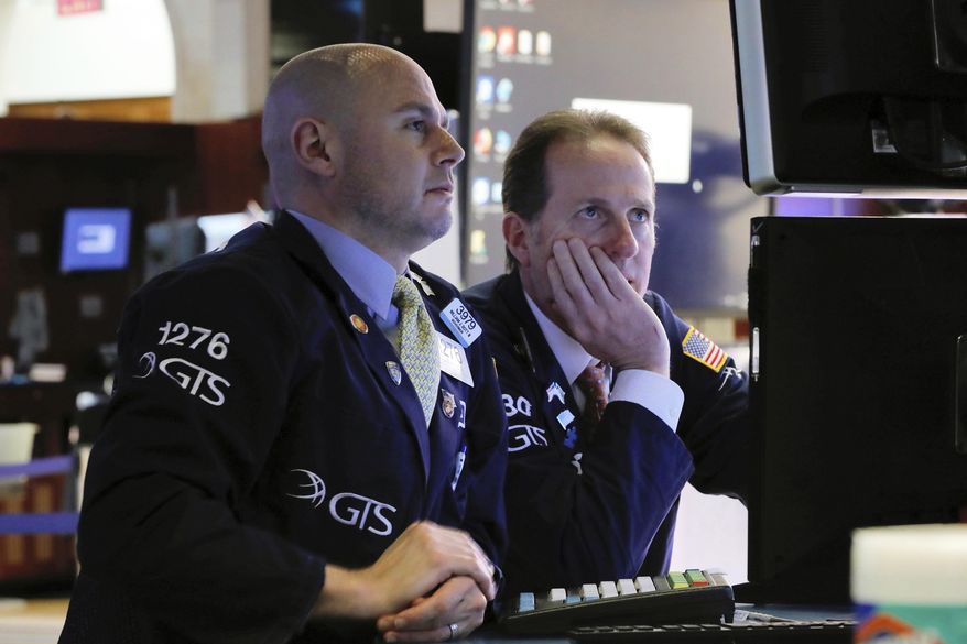 FILE- In this Jan. 30, 2019, file photo specialists Mario Picone, left, and Glenn Carrell work on the floor of the New York Stock Exchange. The U.S. stock market opens at 9:30 a.m. EST on Monday, Feb. 4. (AP Photo/Richard Drew, File)