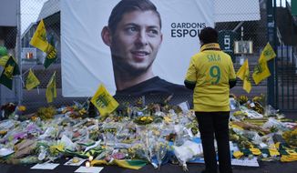 FILE - In this Wednesday, Jan. 30, 2019, file photo, a Nantes soccer team supporters stops by a poster of Argentinian player Emiliano Sala and reading &amp;quot;Let&#x27;s keep hope&amp;quot; outside La Beaujoire stadium before the French soccer League One match Nantes against Saint-Etienne, in Nantes, western France. On Sunday, Feb. 3, 2019, the man leading a private search for the missing plane carrying Argentine soccer player Emiliano Sala says the wreckage has been found. (AP Photo/Thibault Camus, File)