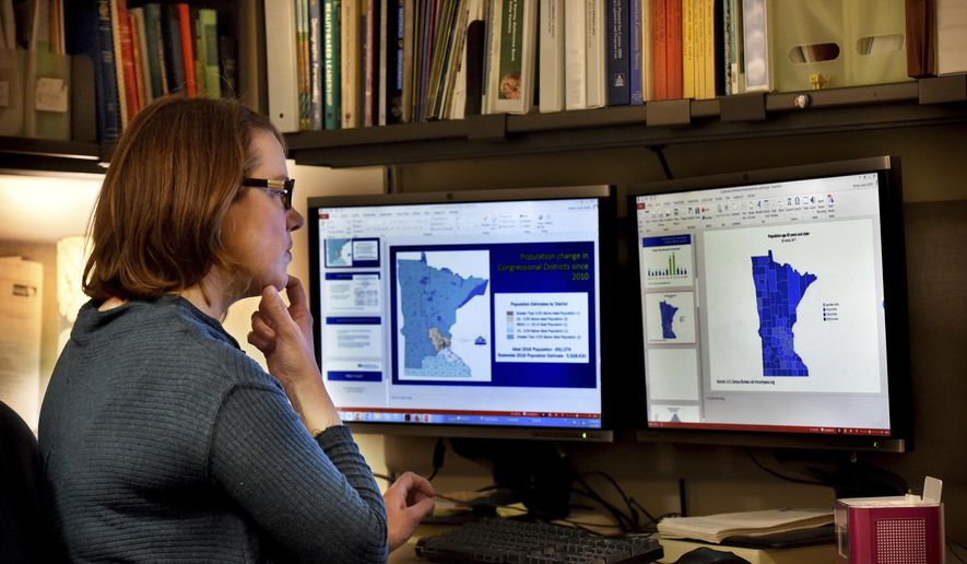 In this Friday, Feb. 1, 2019, photo Minnesota state demographer Susan Brower, works in her St. Paul, Minn. Brower is updating address lists and holding workshops to prepare cities and counties for the 2020 census. (Jean Pieri/Pioneer Press via AP)