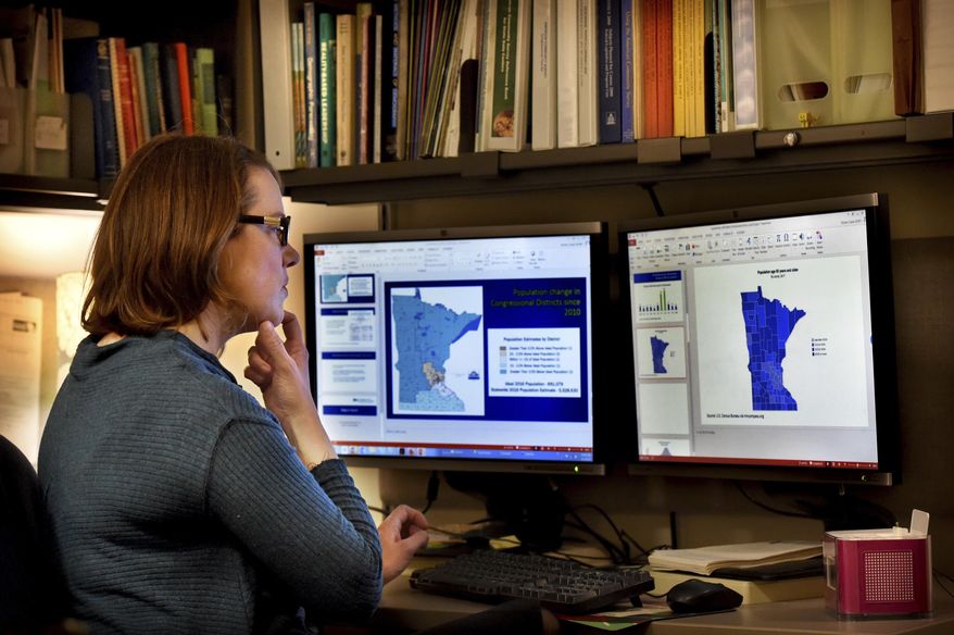 In this Friday, Feb. 1, 2019, photo Minnesota state demographer Susan Brower, works in her St. Paul, Minn. Brower is updating address lists and holding workshops to prepare cities and counties for the 2020 census. (Jean Pieri/Pioneer Press via AP)