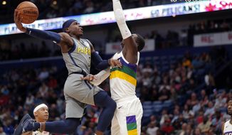 Indiana Pacers guard Aaron Holiday (3) goes to the basket against New Orleans Pelicans forward Cheick Diallo in the first half of an NBA basketball game in New Orleans, Monday, Feb. 4, 2019. (AP Photo/Gerald Herbert)