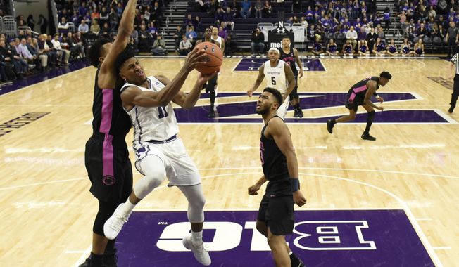 Northwestern guard Anthony Gaines, center, goes to the basket as Penn State forward Lamar Stevens, left, defends him during the first half of an NCAA college basketball game Monday, Feb. 4, 2019, in Evanston, Ill. (AP Photo/David Banks)