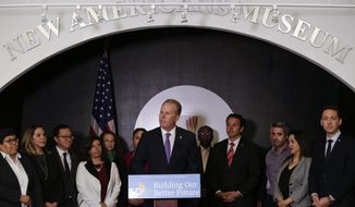 San Diego Mayor Kevin Faulconer, center, speaks during a news conference at the New Americans Museum, Monday, Feb. 4, 2019, in San Diego. Faulconer announced a new plan Monday designed to welcome immigrants and new citizens to San Diego. (AP Photo/Gregory Bull)