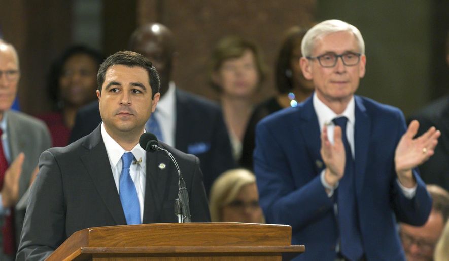 FILE - In this Jan. 7, 2019 file photo, Wisconsin Attorney General Josh Kaul speaks during his address at the inauguration of Gov. Tony Evers, right, at the state Capitol in Madison, Wis. A coalition of labor unions and a Democratic lawmaker filed another lawsuit Monday, Feb. 4, 2019, challenging measures Wisconsin Republicans approved in a lame-duck session, alleging in part that the new laws illegally weaken the governor and attorney general while placing an "incalculable" financial burden on taxpayers. (AP Photo/Andy Manis, File)