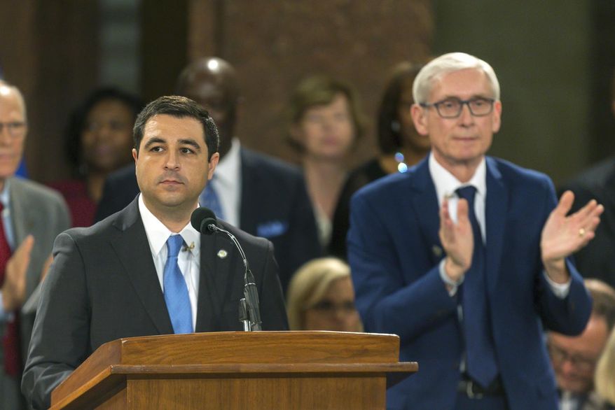 FILE - In this Jan. 7, 2019 file photo, Wisconsin Attorney General Josh Kaul speaks during his address at the inauguration of Gov. Tony Evers, right, at the state Capitol in Madison, Wis. A coalition of labor unions and a Democratic lawmaker filed another lawsuit Monday, Feb. 4, 2019, challenging measures Wisconsin Republicans approved in a lame-duck session, alleging in part that the new laws illegally weaken the governor and attorney general while placing an "incalculable" financial burden on taxpayers. (AP Photo/Andy Manis, File)