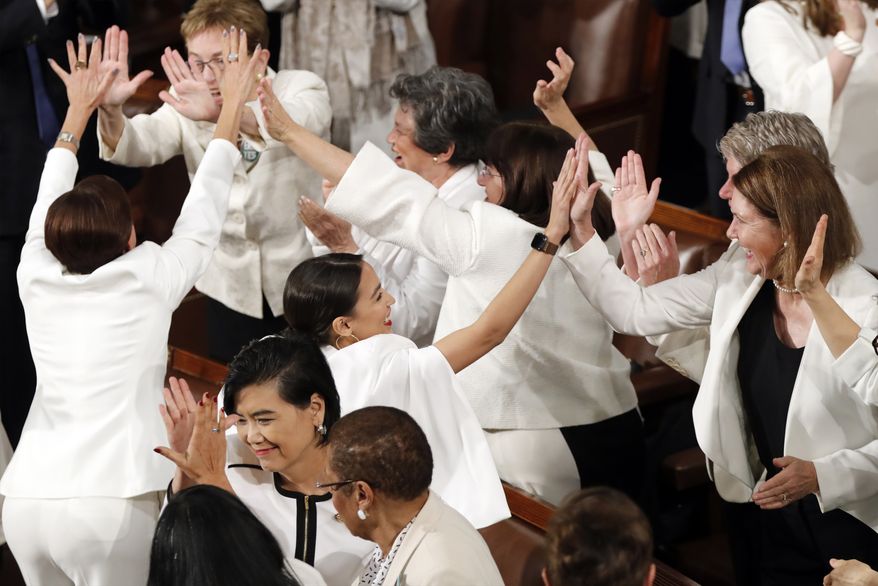 Women members of Congress, including Rep. Alexandria Ocasio-Cortez, D-N.Y., center, cheer after President Donald Trump acknowledges more women in Congress during his State of the Union address to a joint session of Congress on Capitol Hill in Washington, Tuesday, Feb. 5, 2019. (AP Photo/J. Scott Applewhite) **FILE**