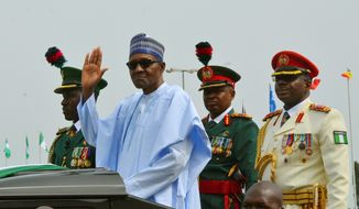 In this Monday, Oct. 1, 2018, file photo, Nigerian President Muhammadu Buhari waves to the crowd during the 58th anniversary celebrations of Nigerian independence, in Abuja, Nigeria. The United States and European Union are expressing concern after Nigeria&#39;s president suspended the country&#39;s chief justice on Friday, Jan. 25, 2019, three weeks before the presidential election, with the U.S. warning it could &quot;cast a pall&quot; over the vote. (AP Photo/Olamikan Gbemiga, File)