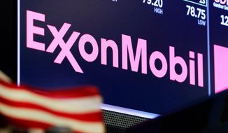 FILE - In this April 23, 2018, file photo, the logo for ExxonMobil appears above a trading post on the floor of the New York Stock Exchange. Exxon Mobil is making a big bet on the future of exporting natural gas. Exxon and Qatar Petroleum announced Tuesday, Feb. 5, 2019, that they will go ahead with a $10 billion project to expand a liquefied natural gas export plant on the Texas Gulf Coast. (AP Photo/Richard Drew, File)