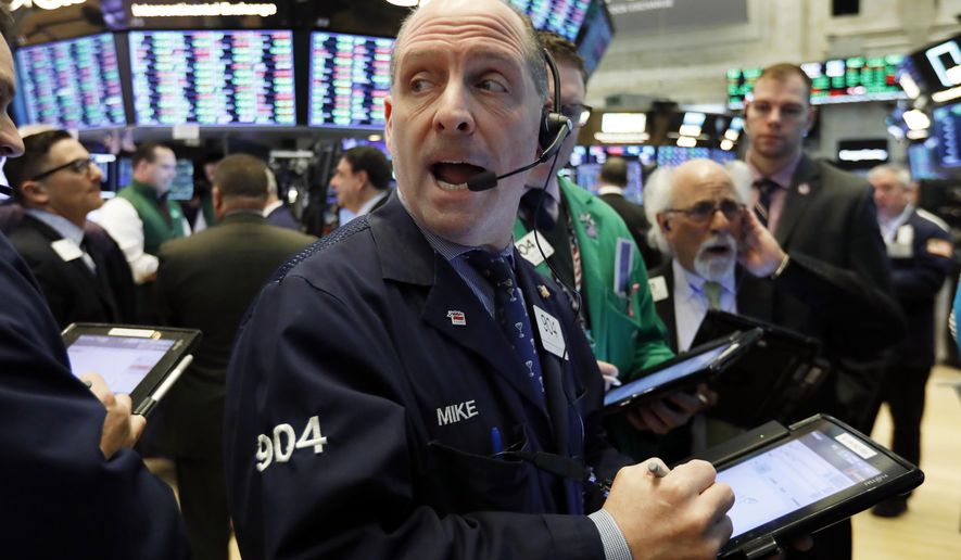FILE- In this Tuesday, Jan. 29, 2019, file photo trader Michael Unkonis, center, works on the floor of the New York Stock Exchange. The U.S. stock market opens at 9:30 a.m. EST on Tuesday, Feb. 5. (AP Photo/Richard Drew, File)