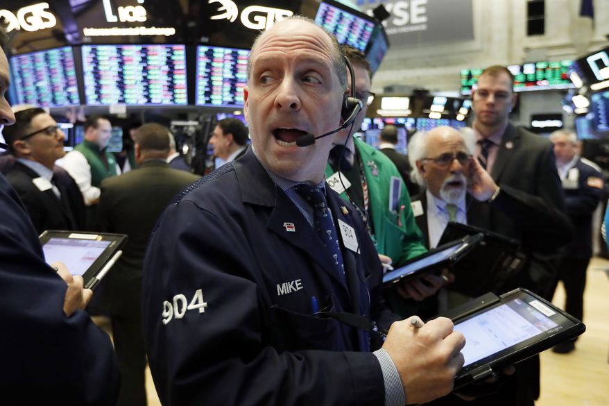 FILE- In this Tuesday, Jan. 29, 2019, file photo trader Michael Unkonis, center, works on the floor of the New York Stock Exchange. The U.S. stock market opens at 9:30 a.m. EST on Tuesday, Feb. 5. (AP Photo/Richard Drew, File)