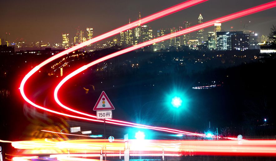 Long exposure picture shows car lights of commuters driving down to the city of Frankfurt, Germany, Tuesday, Feb. 5, 2019. (AP Photo/Michael Probst)