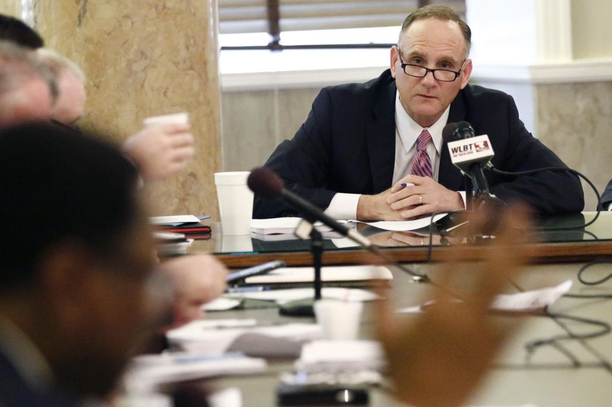 House Judiciary A Committee chairman Mark Baker, R-Brandon, background, listens as Rep. Ed Blackmon, D-Canton, foreground, argues against the Landowner Protection Act, which would reduce the liability of business owners when someone is injured on their property, during a meeting of the committee, Tuesday, Feb. 5, 2019, in Jackson, Miss. The measure passed the committee, but other representatives still wanted to talk about the bill after Baker declared it passed, and Blackmon chastised Baker for ending the meeting without being recognized for a question. (AP Photo/Rogelio V. Solis)