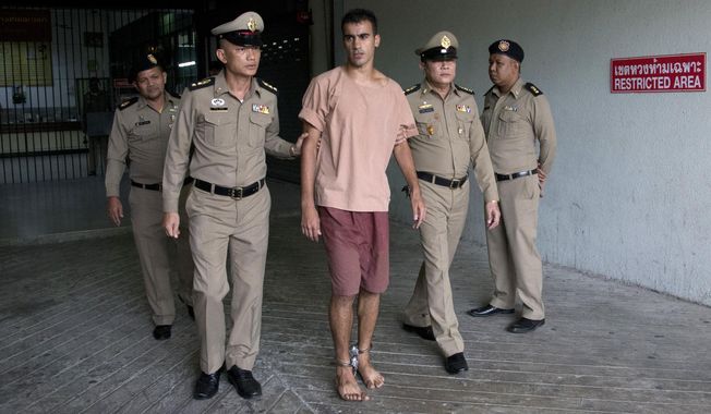 Bahraini Hakeem al-Araibi, center, leaves the criminal court in Bangkok, Thailand, Bangkok, Thailand, Monday, Feb. 4, 2019. The soccer player who has refugee status in Australia told a Thai court Monday that he refuses to be voluntarily extradited to Bahrain, which has asked for his return to serve a prison sentence for a crime he denies committing.(AP Photo/Sakchai Lalit)