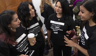 Women opposed to the Neomi Rao, President Donald Trump&#39;s nominee for a seat on the D.C. Circuit Court of Appeals, stand outside the Senate Judiciary Committee as she appears for her confirmation hearing, on Capitol Hill in Washington, Tuesday, Feb. 5, 2019. Liberal activists are targeting Rao for what they call her extreme views on race, sexual assault and LGBT rights. (AP Photo/J. Scott Applewhite)