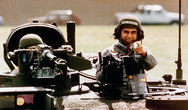Democratic presidential candidate Michael Dukakis gets a free ride in one of General Dynamics&#x27; new M1-A-1 battle tanks at its land systems division in Sterling Heights, Michigan, on Tuesday, Sept. 13, 1988. Dukakis took time out to tell General Dynamics workers that he&#x27;s not soft on defense. (AP Photo/Michael E. Samojeden)