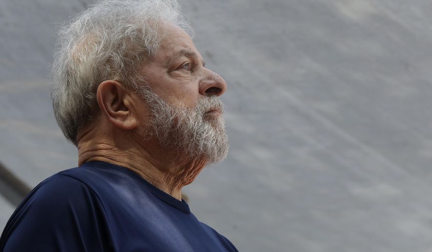 FILE - In this April 7, 2018 file photo, former Brazilian President Luiz Inacio Lula da Silva looks on before speaking to supporters outside the Metal Workers Union headquarters in Sao Bernardo do Campo, Brazil. Da Silva was sentenced to more than 12 years in prison on Feb. 6, 2019 for a second conviction of corruption and money laundering, while already serving of 12 years and 11 months. Da Silva denies guilt in both cases and is expected to appeal the latest sentence. (AP Photo/Andre Penner, File)