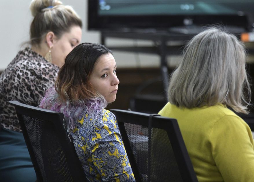 Katrina Silk, middle, sits in a Morton County Courtroom on Tuesday, Feb. 5, 2019 during her bench trial on charges related to her arrest while protesting the construction of the Dakota Access Pipeline south of Mandan, N.D. Silk was convicted Tuesday of obstructing a government function. But, Judge David Reich acquitted Silk on four other misdemeanor charges stemming from her arrest in a field along the pipeline route in October 2016. (Mike McCleary/The Bismarck Tribune via AP)