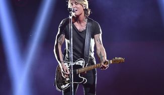 FILE - In this Nov. 14, 2018, file photo, Country music star Keith Urban performs at the 52nd annual CMA Awards at Bridgestone Arena in Nashville, Tenn. Urban will perform at the NHL’s Stadium Series outdoor game in Philadelphia between the Penguins and Flyers on Feb. 23. (Photo by Charles Sykes/Invision/AP, File)