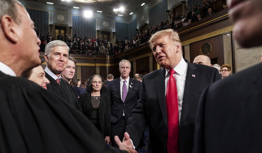 President Donald Trump talks to Supreme Court Chief Justice John Roberts while leaving the House chamber after giving his State of the Union address to a joint session of Congress, Tuesday, Feb. 5, 2019 at the Capitol in Washington. (Doug Mills/The New York Times via AP, Pool)