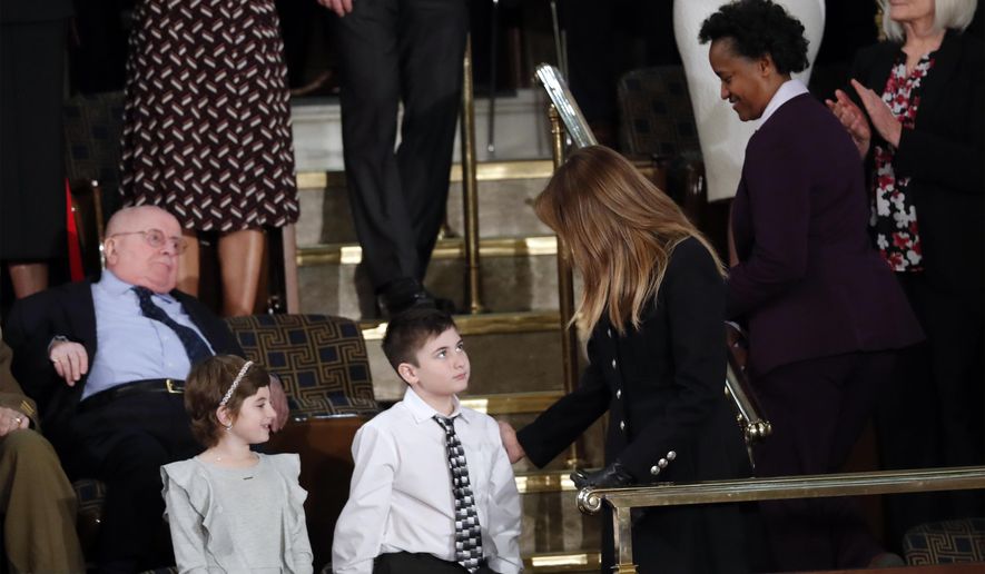 Grace Eline and Joshua Trump greet first lady Melania Trump before President Donald Trump delivers his State of the Union address to a joint session of Congress on Capitol Hill in Washington, Tuesday, Feb. 5, 2019. (AP Photo/J. Scott Applewhite)
